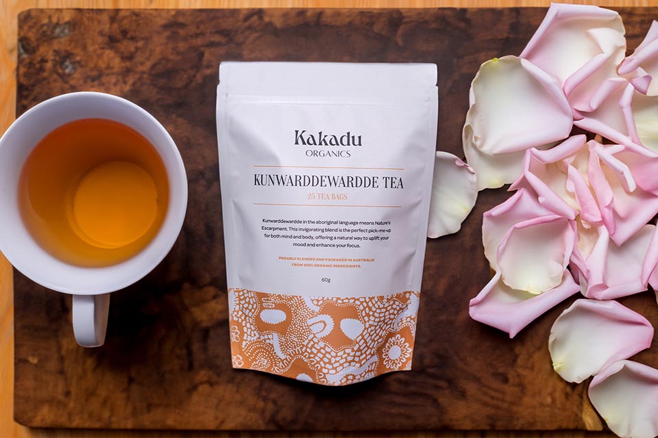 Cup of tea, package of tea and pink rose petals