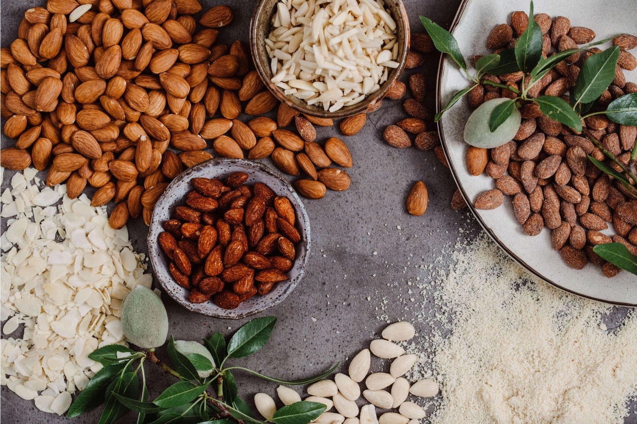 an arrangement of nuts in bowls on a table