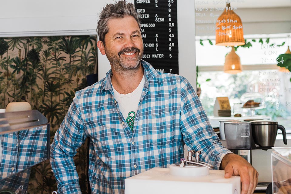 Smiling man standing in cafe