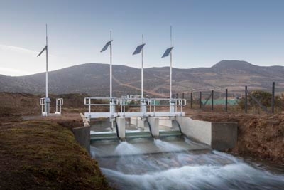 Dam with water flowing over spillway