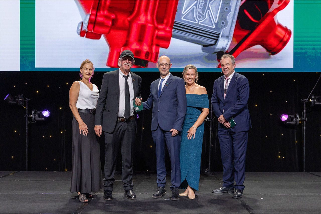 People on a stage recieving an award.