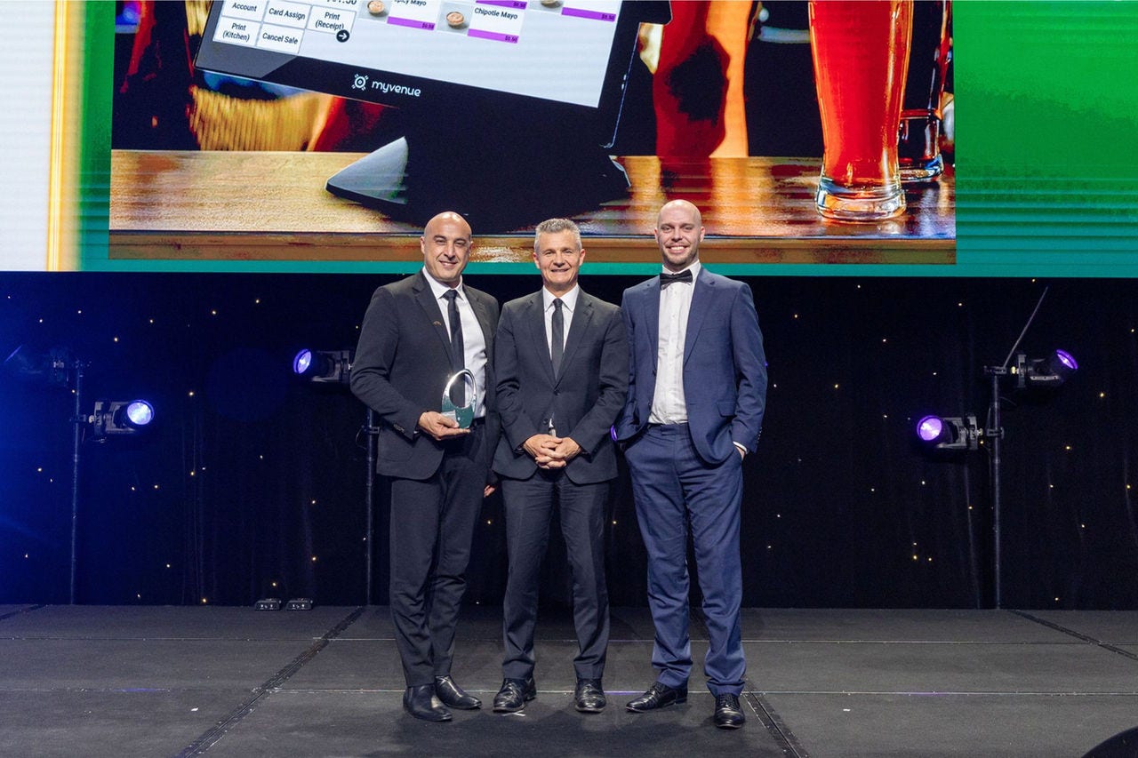 People on a stage receiving an award