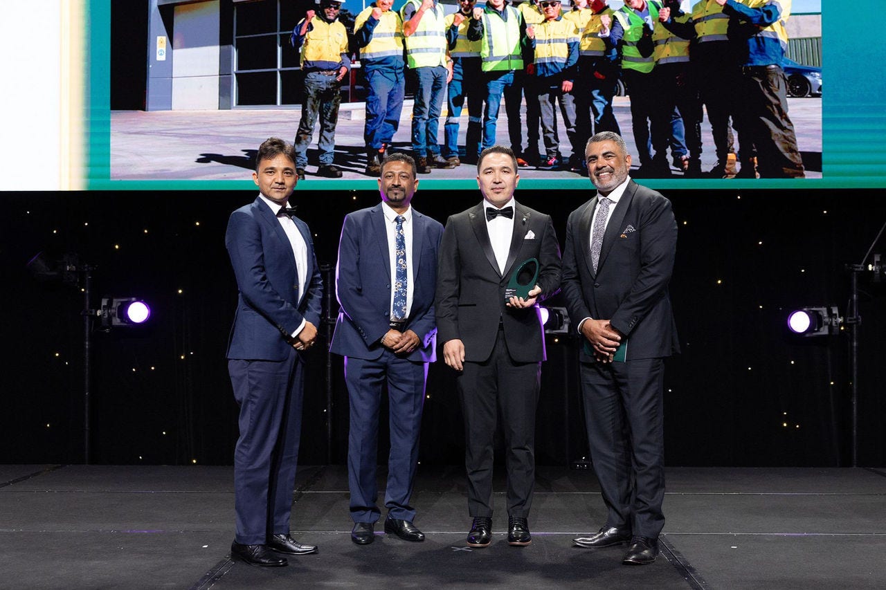 People on a stage recieving an award.