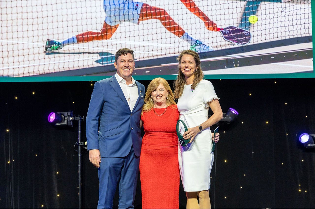 People on a stage recieving an award.