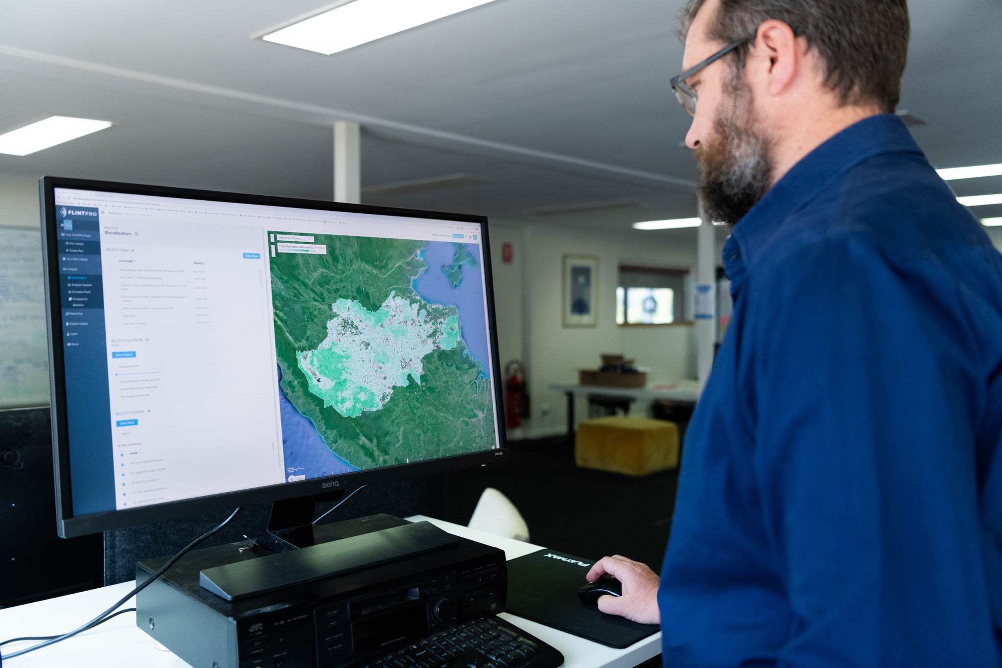 man-on-computer-looking-at-map