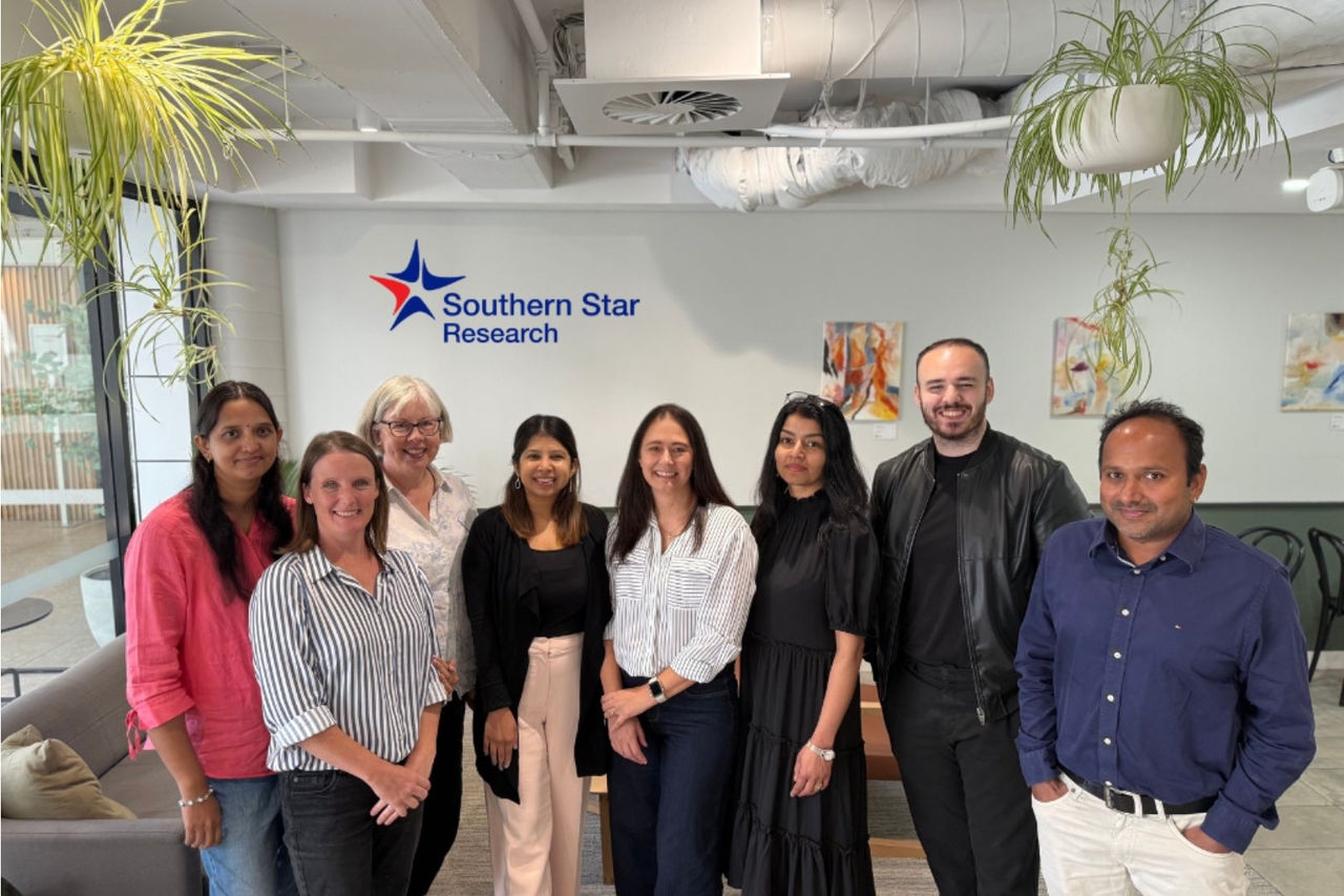 a group of people pose for the camera in an office lobby