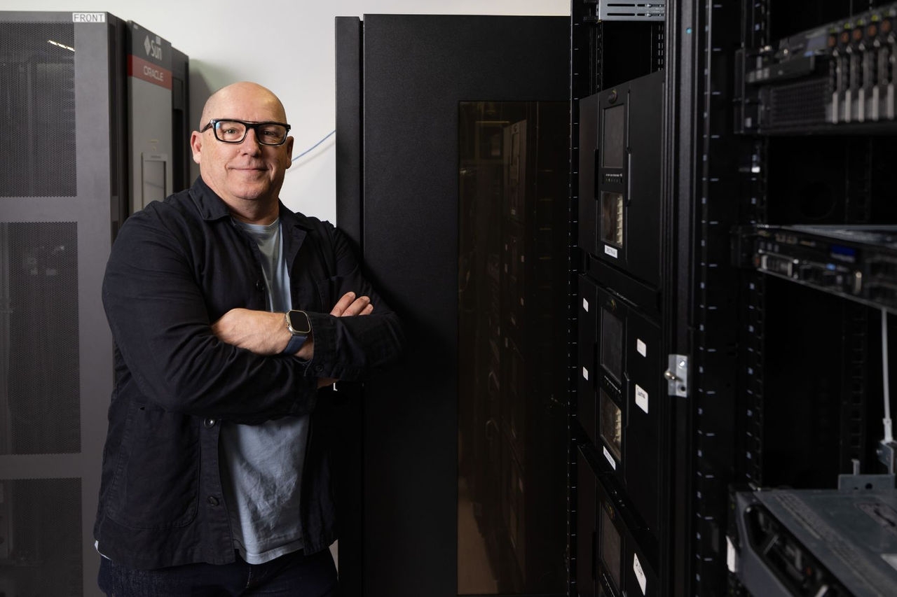 man standing in front of computer storage racks