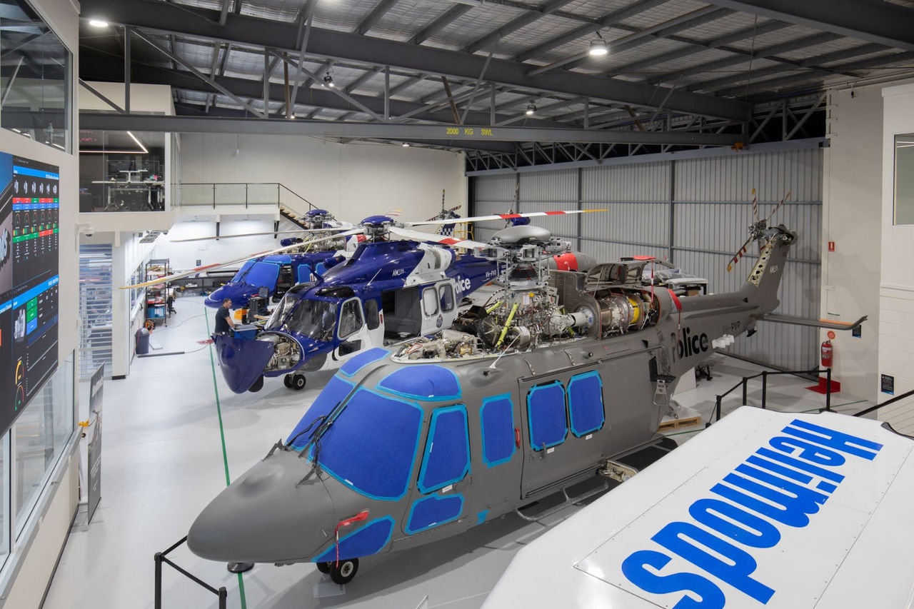 helicopters in various stages of modification inside a factory