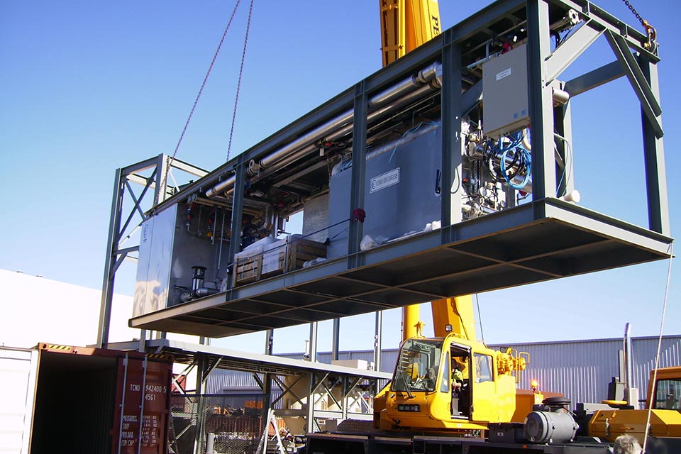 Large structure being lifted by crane