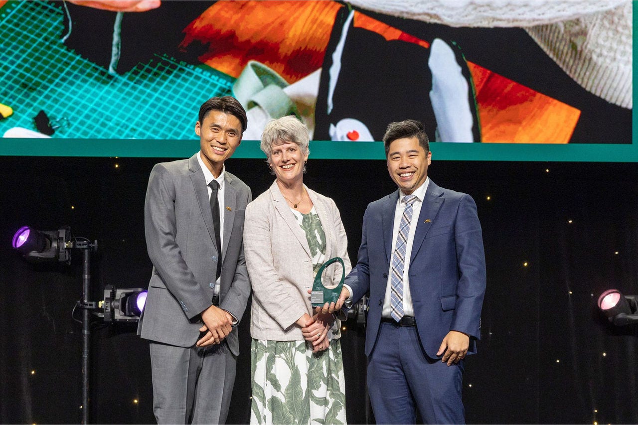 People on a stage recieving an award.