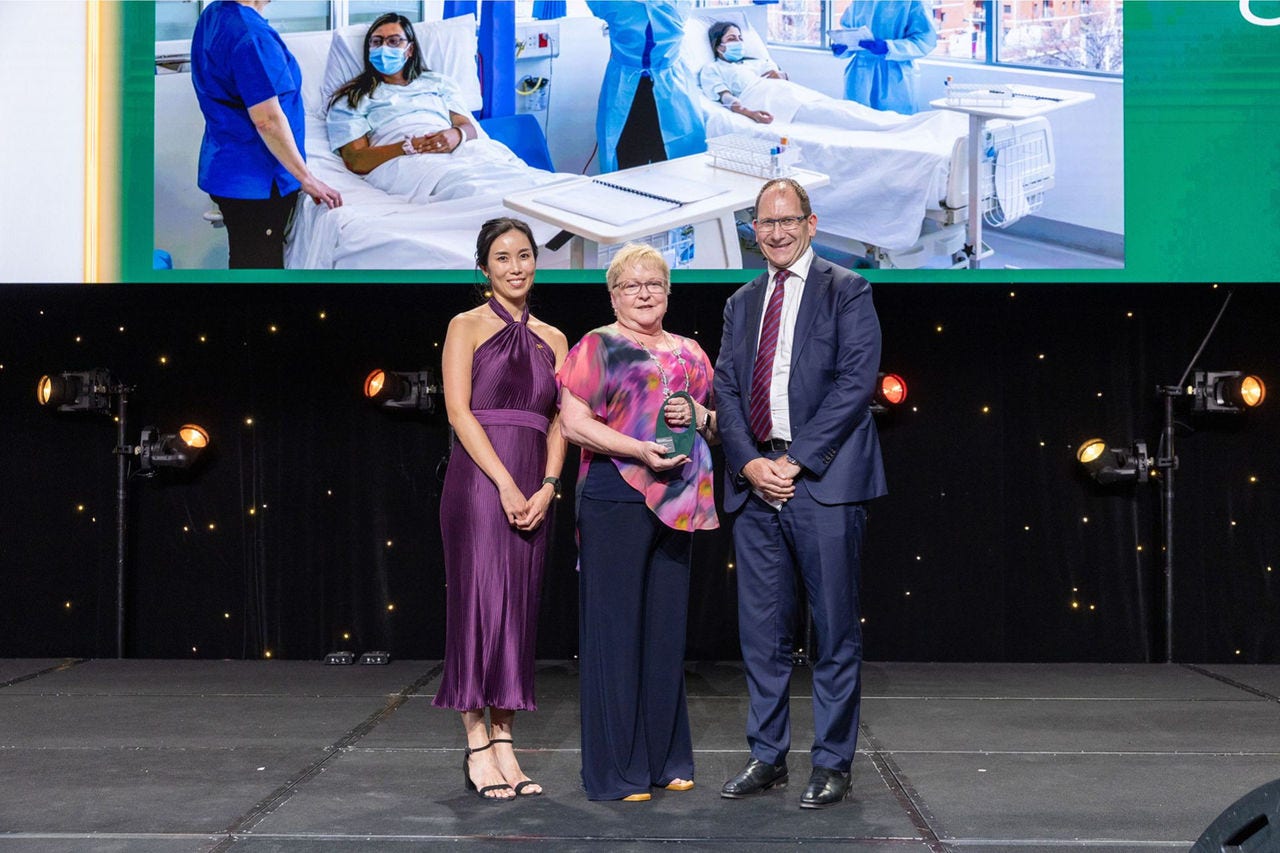 People on a stage receiving an award.