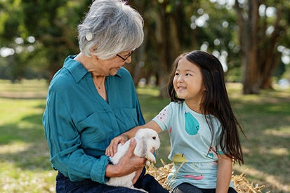 Grandmother with little girl and pet rabbit