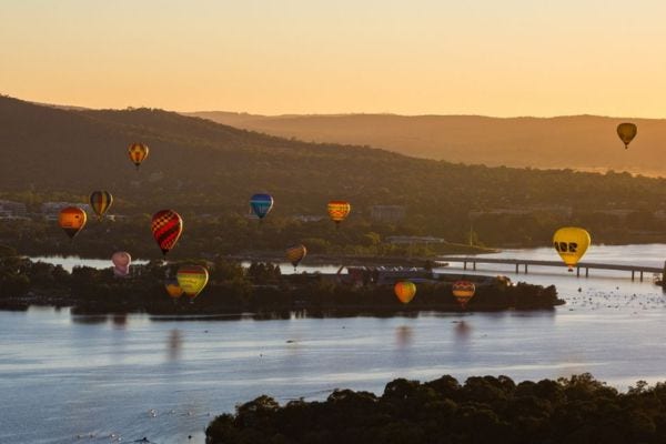 A hot air ballon over a lake at sunset