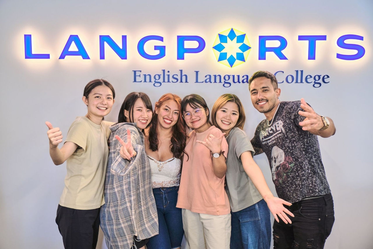 five women and a man pose for a photo