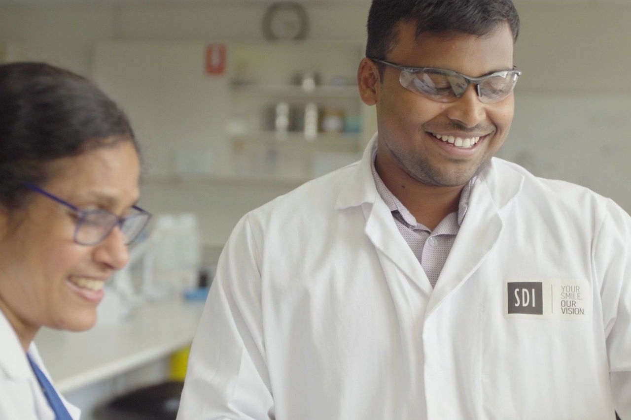female and male lab technicians in lab coats 