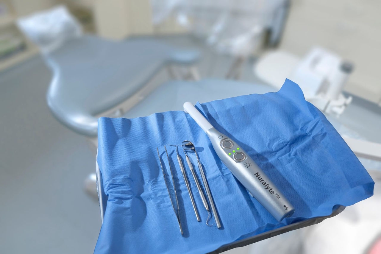 Dentist surgical tools sit on a square of blue material