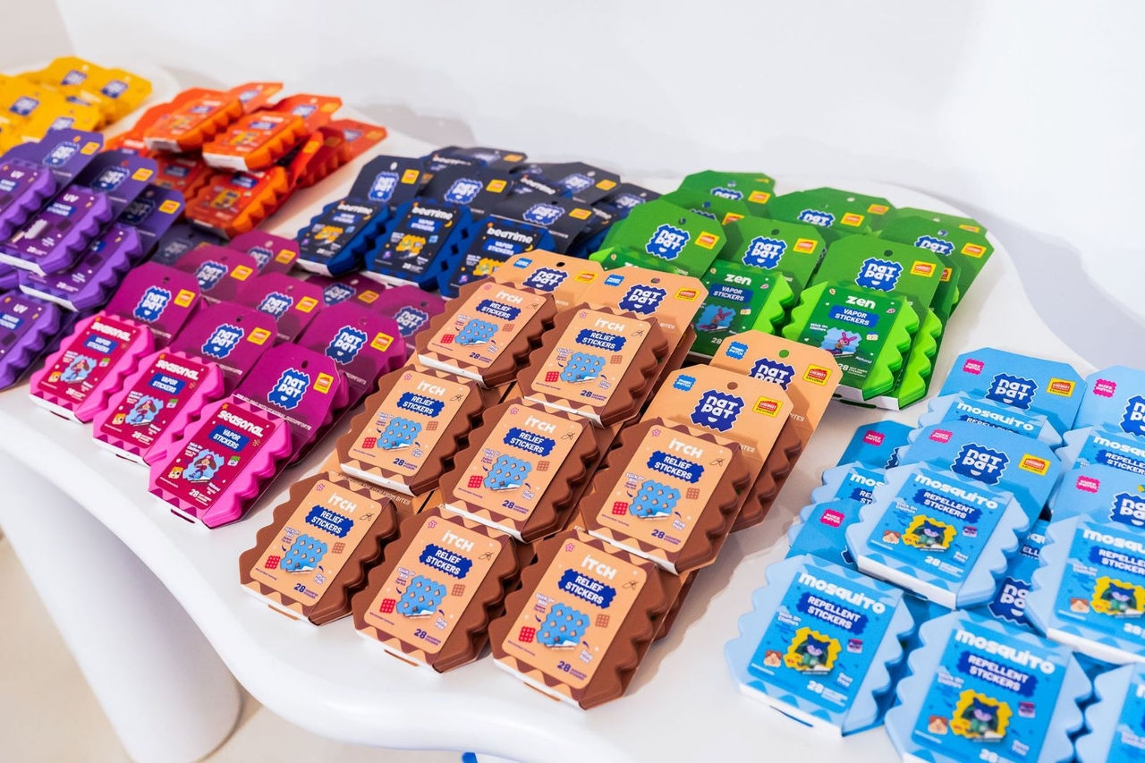 small, plastic stickers are stacked for display grouped by different colours