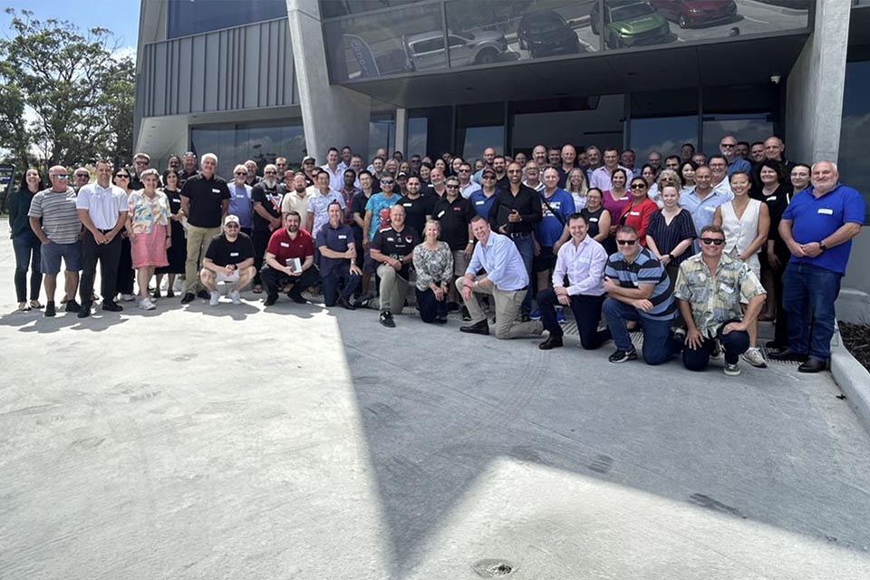 Group of staff standing in front of building