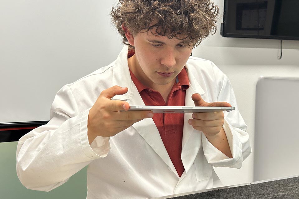 Laboratory technician using a software on a tablet to test a system