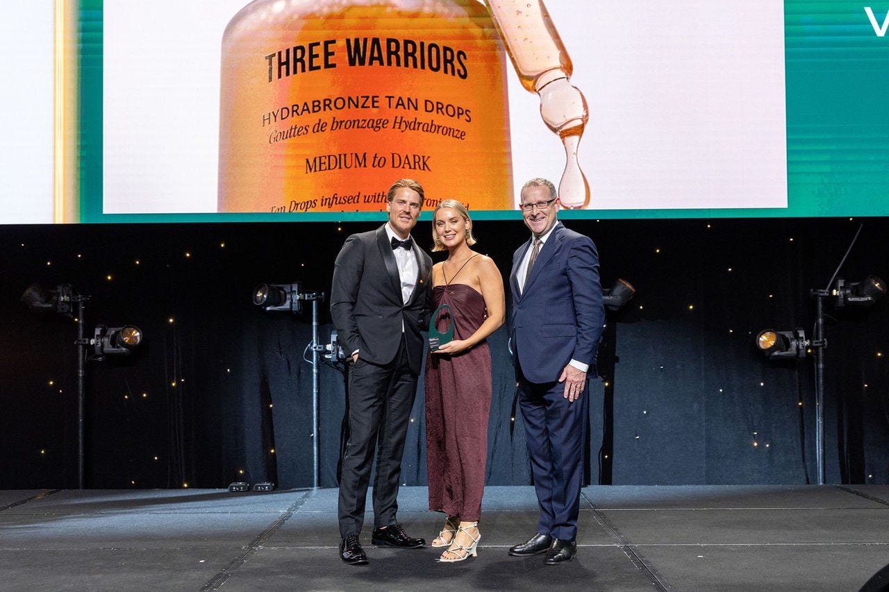 People on a stage receiving an award.