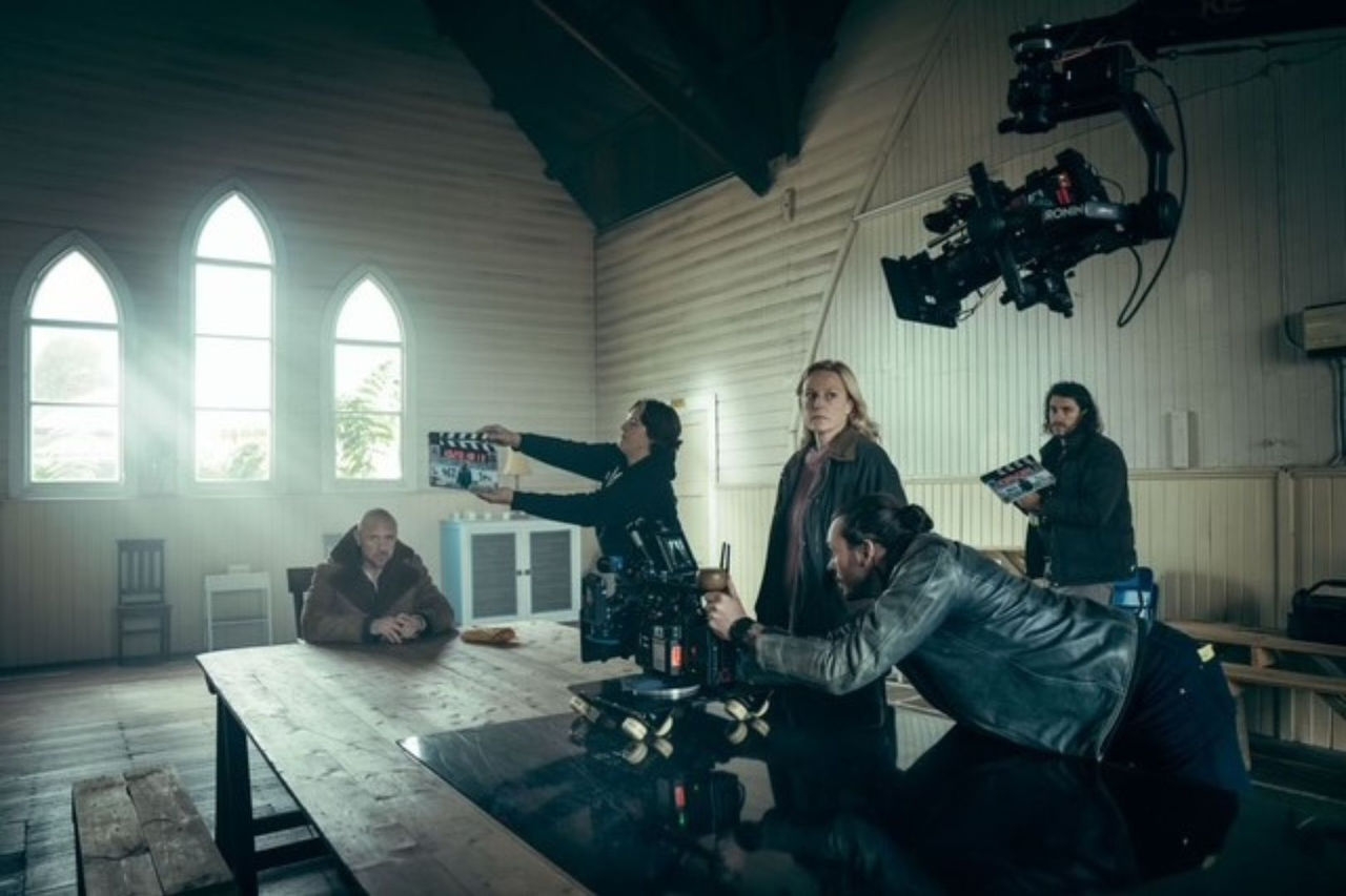 Actors and movie production crew set up a scene ready for filming