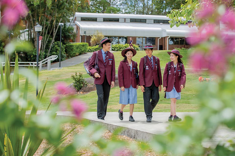 4 students in uniform at school campus