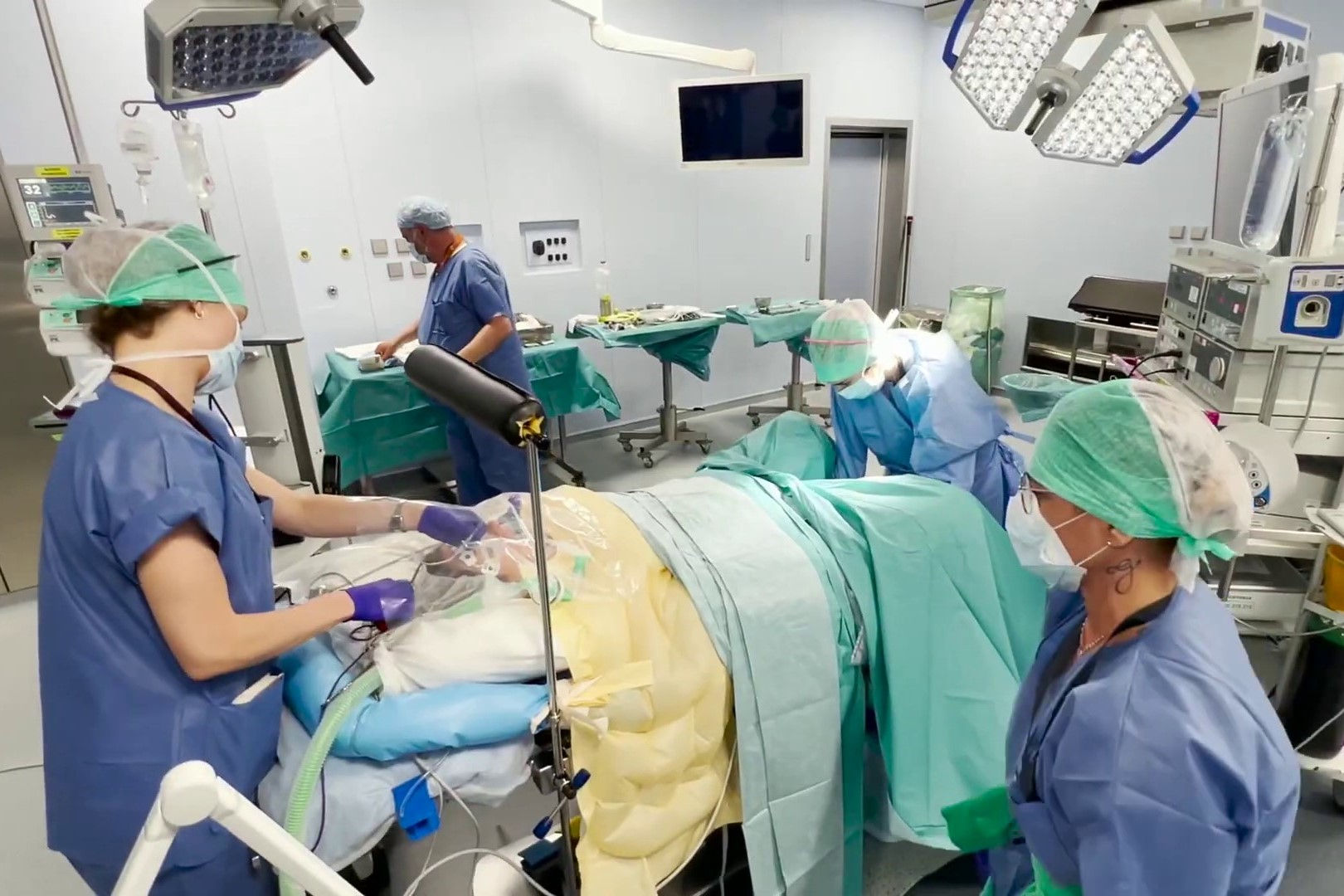 Nurses operating on patient in hospital