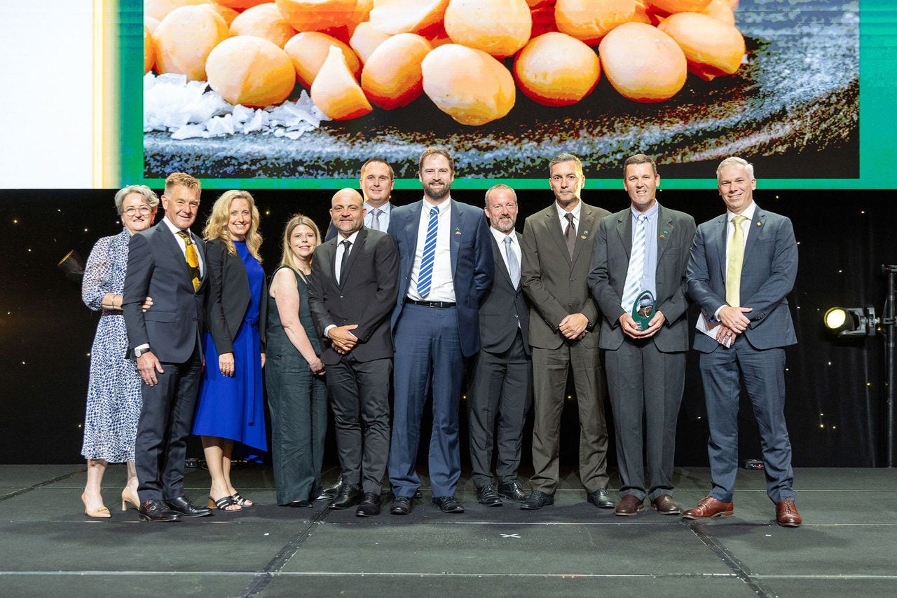 People on a stage recieving an award.