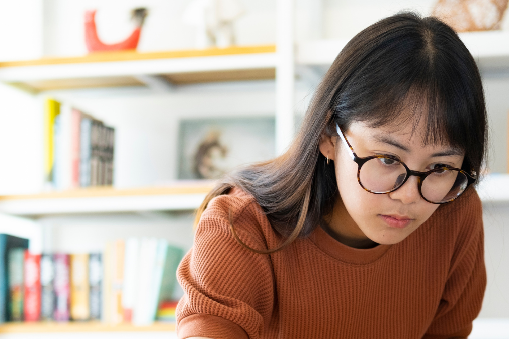 Girl looking at computer in office