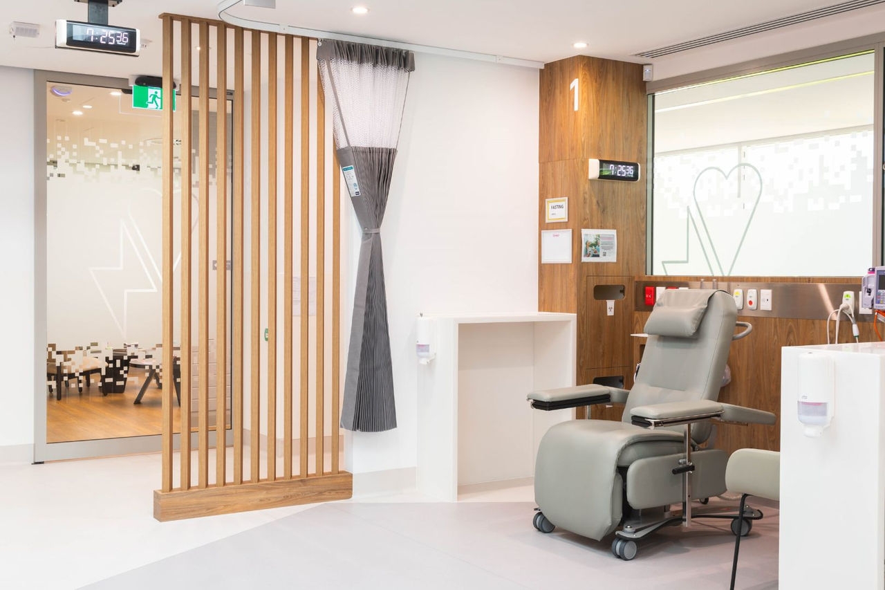 a patient's medical chair sits in a clinical room