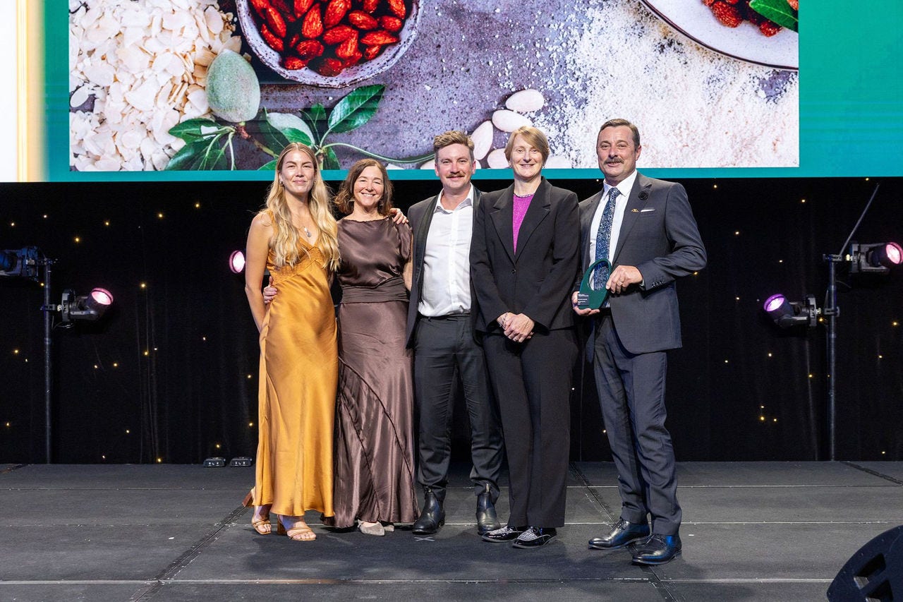 People on a stage receiving an award.