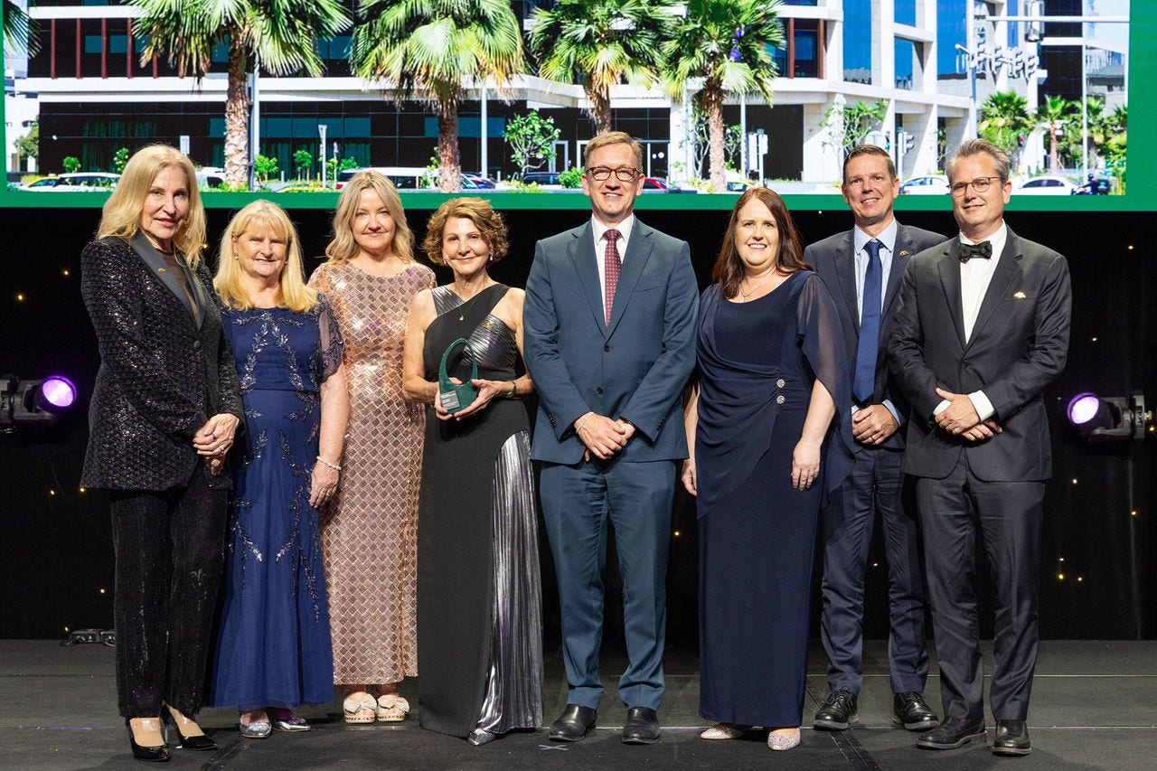 People on a stage recieving an award.