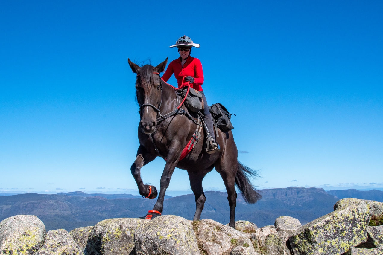 person-horse-riding-on-rocky-terrain