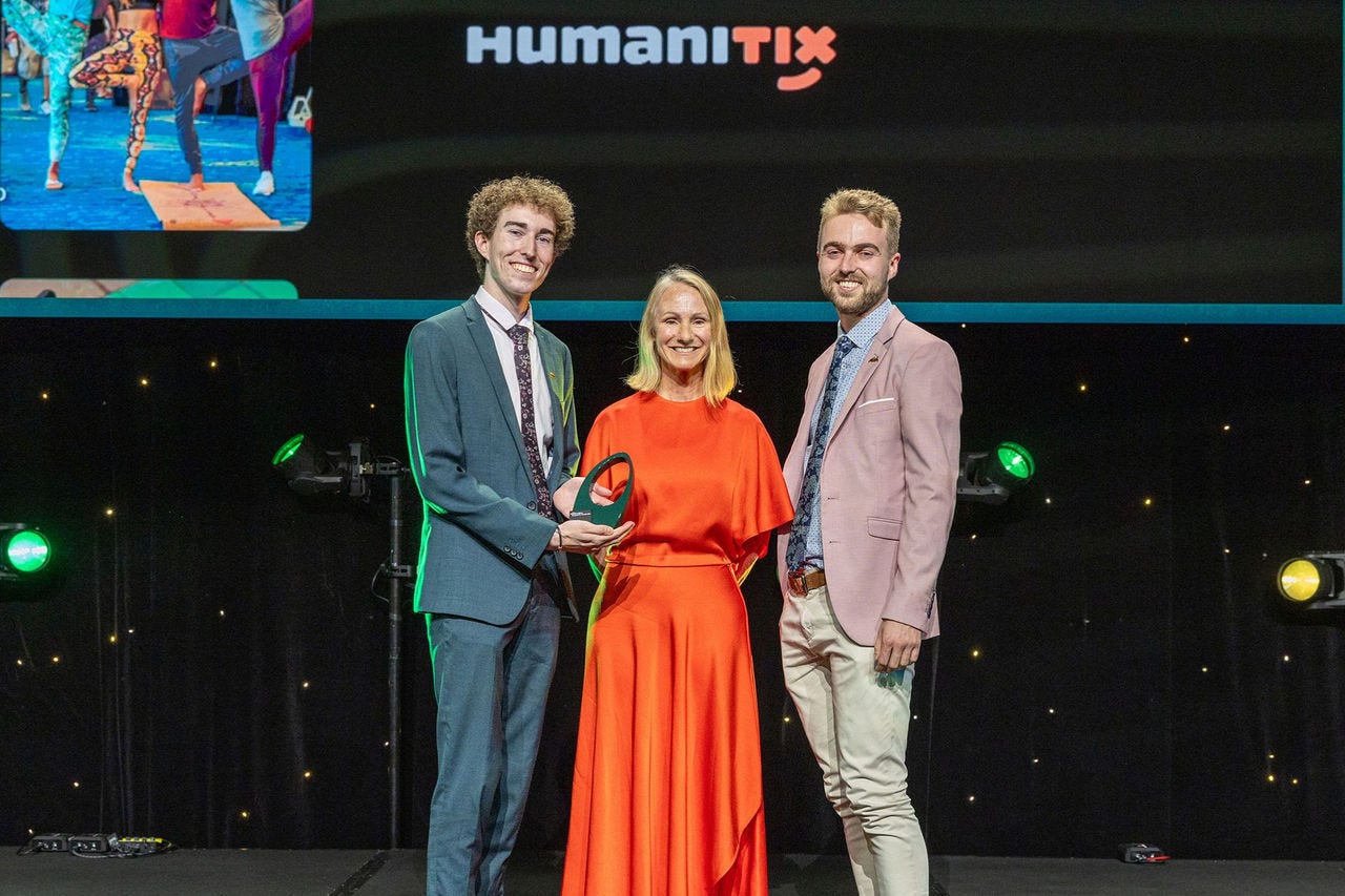 People on a stage recieving an award.