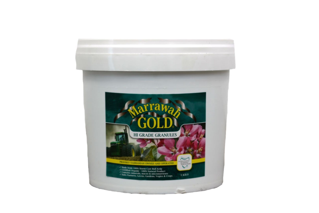 A plastic container with seaweed fertiliser and label showing a pink flower